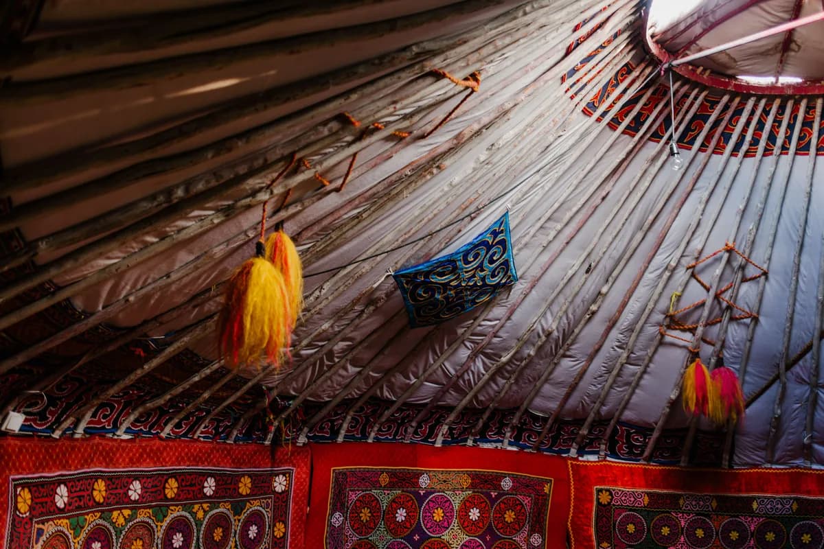 BookNoFees example image: Traditional yurt interior with patterned textiles