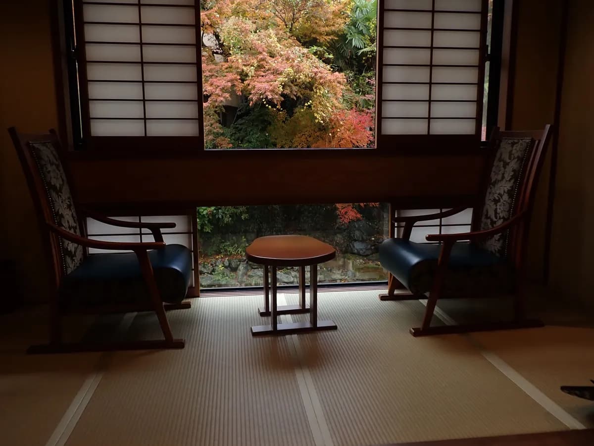 BookNoFees example image: Tatami room with low seating and a view of the garden
