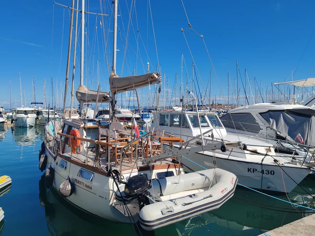 BookNoFees example image: Sailing boats with wooden decks and masts at a harbour jetty