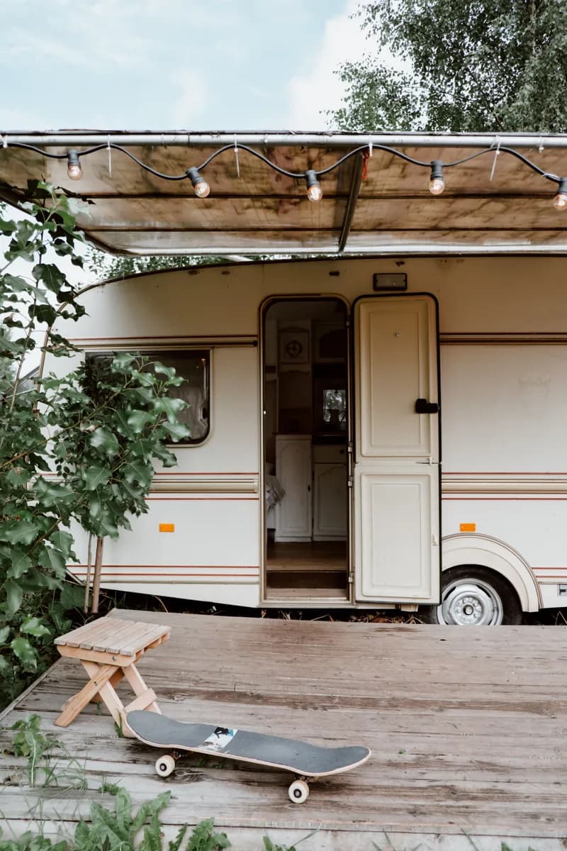 BookNoFees example image: Caravan with its door open next to a wooden terrace