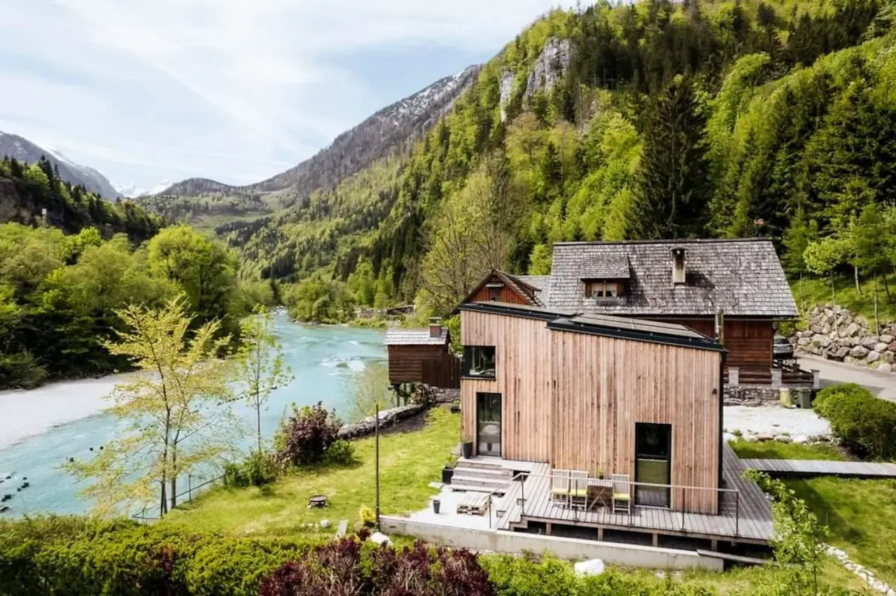 BookNoFees holiday home in Hieflau, Styria, Austria – Exterior view of wooden vacation home with river and mountain backdrop