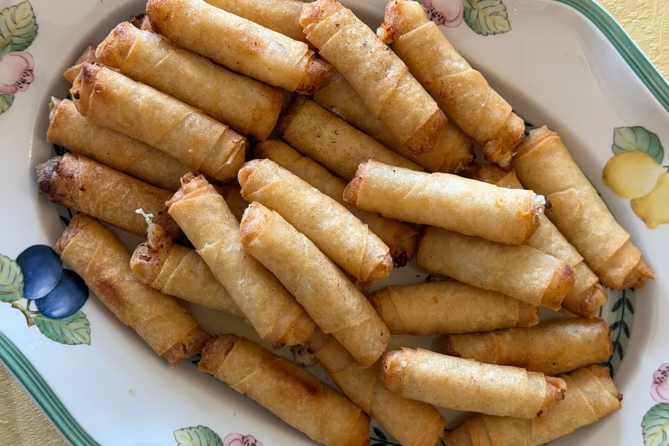 BookNoFees: Example photo: Golden fried spring rolls on a patterned plate