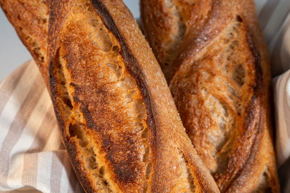 BookNoFees: Example photo: Golden-brown baguettes resting on a checked cloth