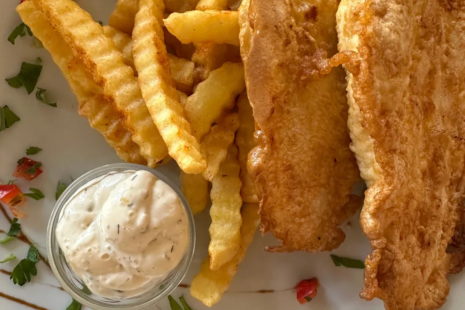 BookNoFees: Example photo: Battered fish fillets with crinkle-cut chips and a small bowl of sauce